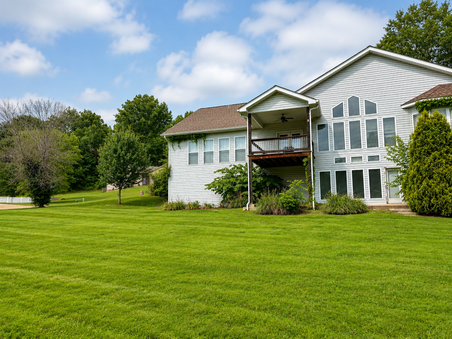 Large white house with open lawn